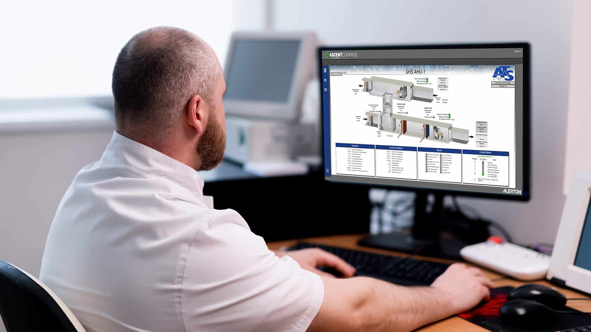 man looking at computer screen showing ATS logo and typing