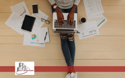 woman working on her laptop around lots of paper work